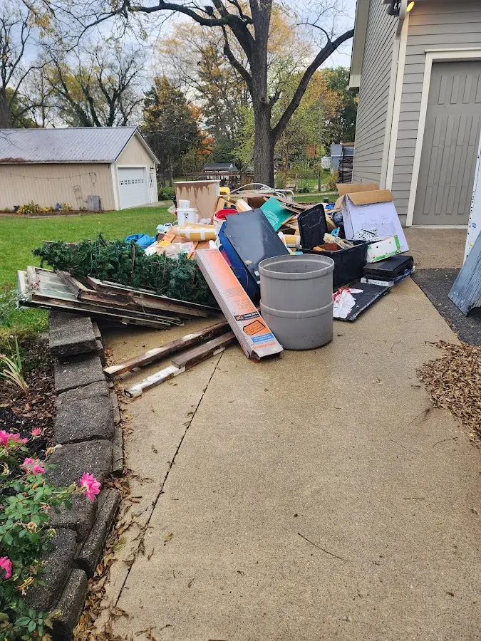 Dumpster being loaded with debris for Residential Dumpster Rental in Lake Mills